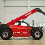 Side view of the Magni TH 5.8P telescopic handler inside an industrial facility.