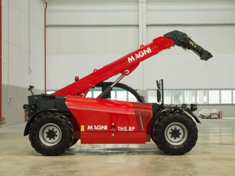 Side view of the Magni TH 5.8P telescopic handler inside an industrial facility.